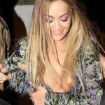 Rita Ora no bra, visible boob outdoors