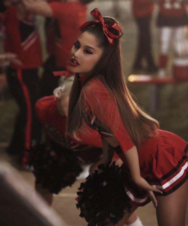 Ariana Grande wearing a cheerleader outfit certainly gets the mind