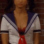 Brenda Song's cleavage on display in a schoolgirl outfit