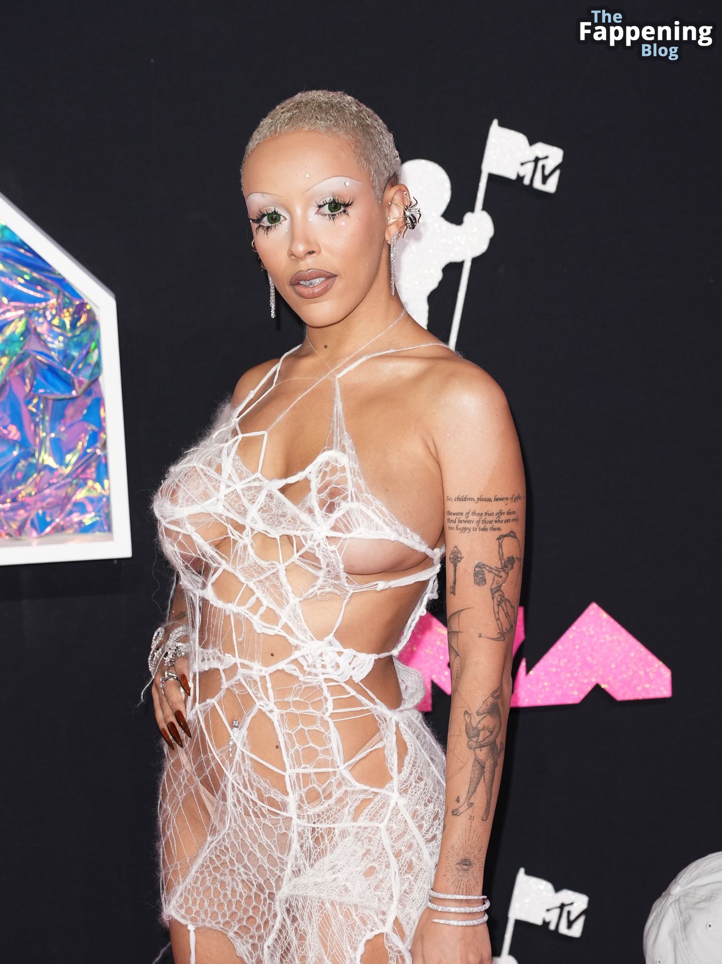 Doja Cat Flashes Her Nude Boobs in a See Through Outfit.jpeg