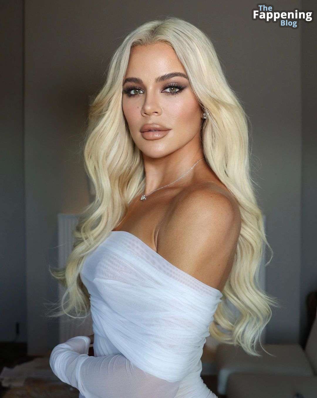 Khloe Kardashian Flaunts Her Curves in a White Dress 6.jpg