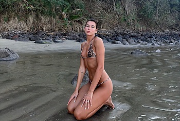 Dua Lipa bikini on a beach