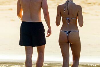 Dua Lipa bikini on a beach