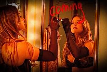 Sydney Sweeney posing in lacy lingerie