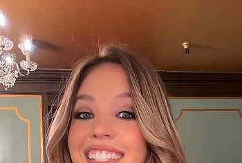 Sydney Sweeney posing in lacy lingerie