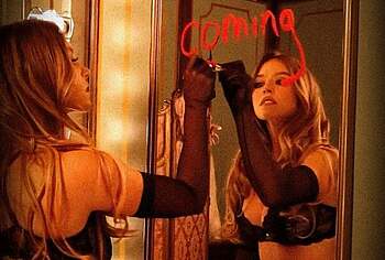 Sydney Sweeney posing in lacy lingerie